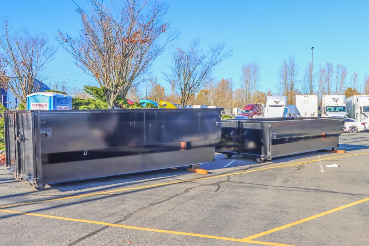 Professional dumpster rental service with roll-off container on residential driveway in Gloucester City